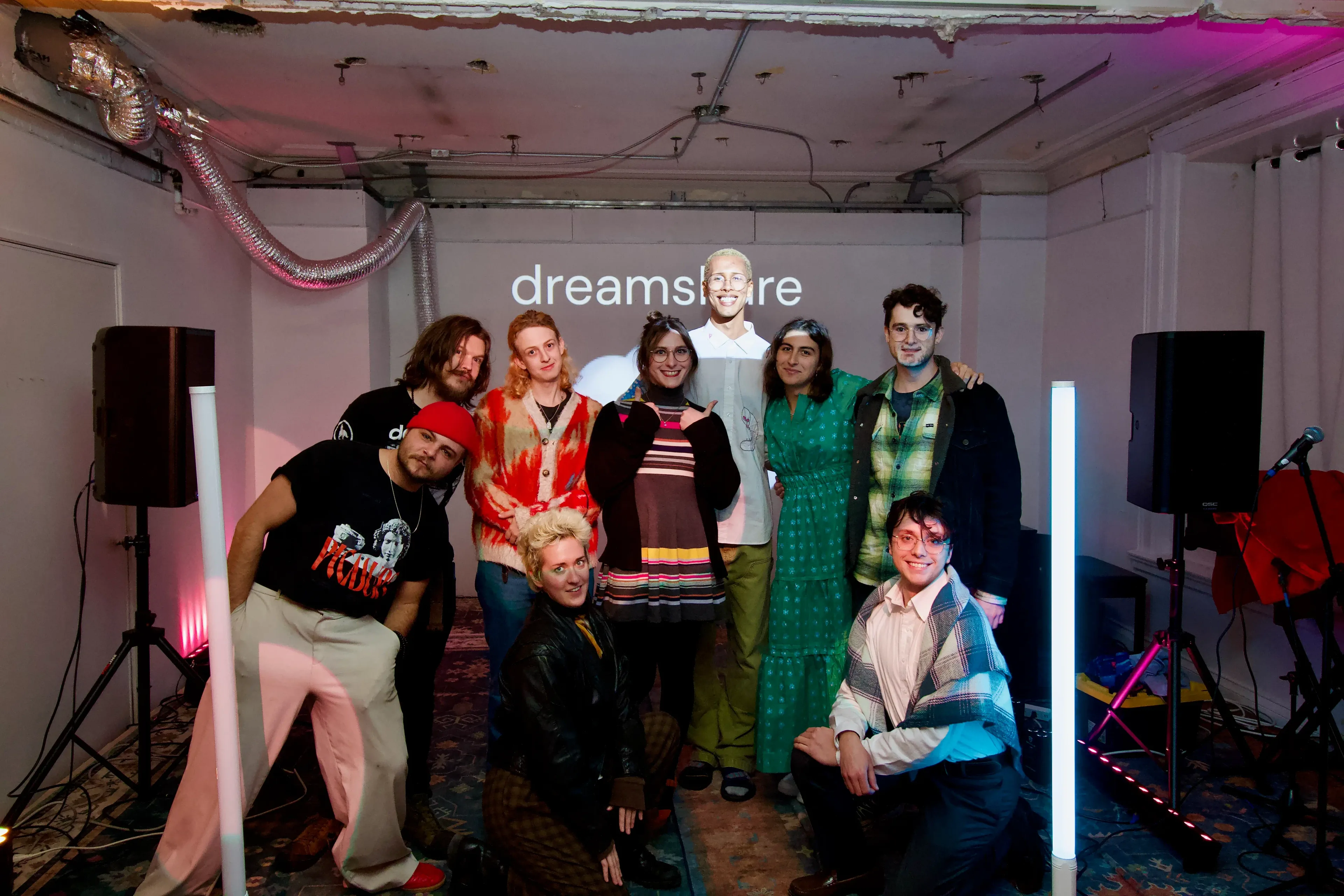 The Dreamshare speakers and organizers gathered together under the projected wordmark